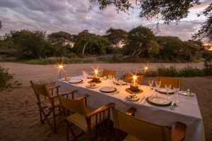 Dinner Set Up By The Riverbed Laba Jongomero Camp