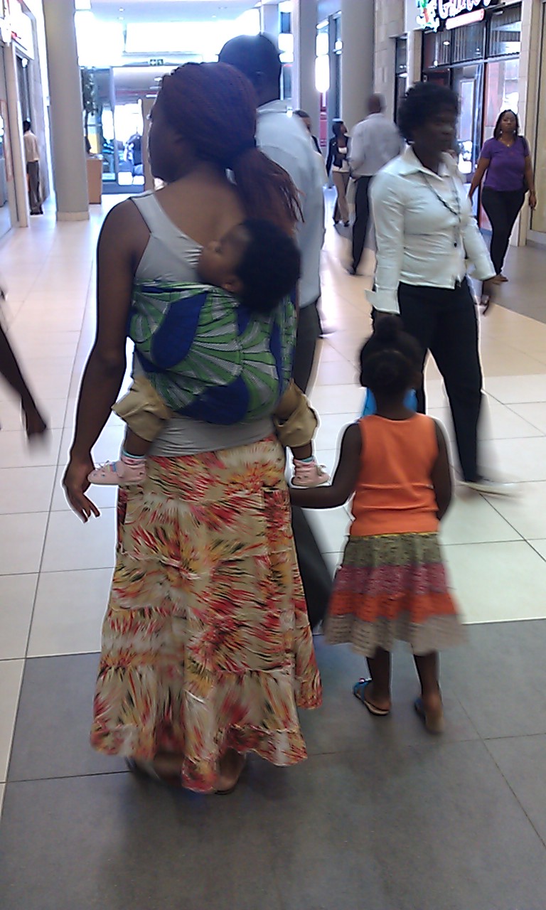 A mother carries her baby in a chitenge sling