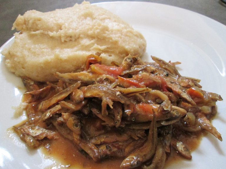 A plate of sadza served with stewed kapenta fish, Zimbabwe